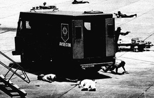 Aquino's body in the foreground. His assassin's body next to the police van